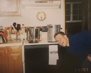 a picture of Eric making candles in the kitchen