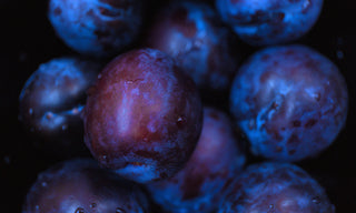plums in a dark backround