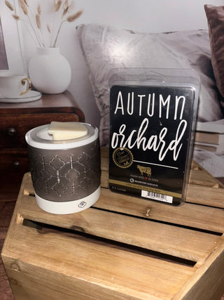 Wax warmer with a package of 'Autumn Orchard' wax melts on a wooden surface