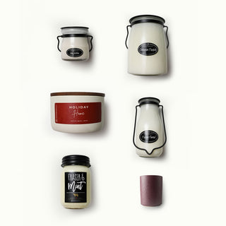 Collection of various candles with labels on a white background