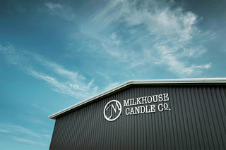 Milkhouse Candle Co. building with logo against a blue sky