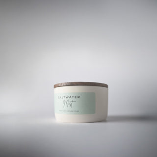 cream creamic statement collection jar with the wood lid on the candle 