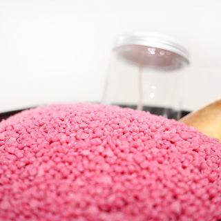 Close-up of pink wax beads with a blurred background