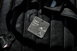 Car air freshener with 'Barn Dance' label on a car seat