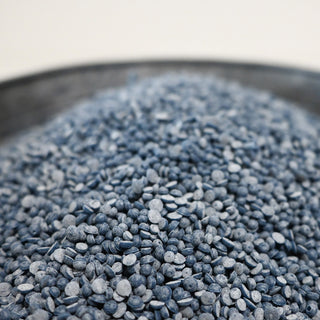 Close-up of blue scented wax beads in a container