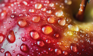 water droplets on a  close up of a red apple