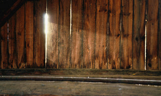 old barn wood that you can see the sun shine through 