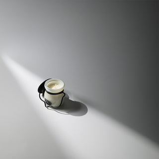 cream jar candle with metal lid off to the side 