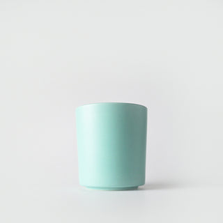 a torquoise colored tumbler of endless sea  candle 