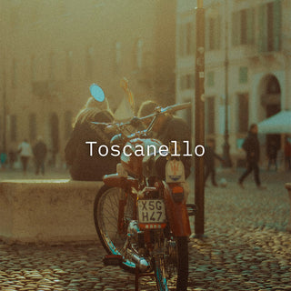toscanello writen on a image in a italian city with a moterbike im front of a couple sitting down 