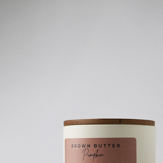 close up of the cream statment collection jar with the wood lid 